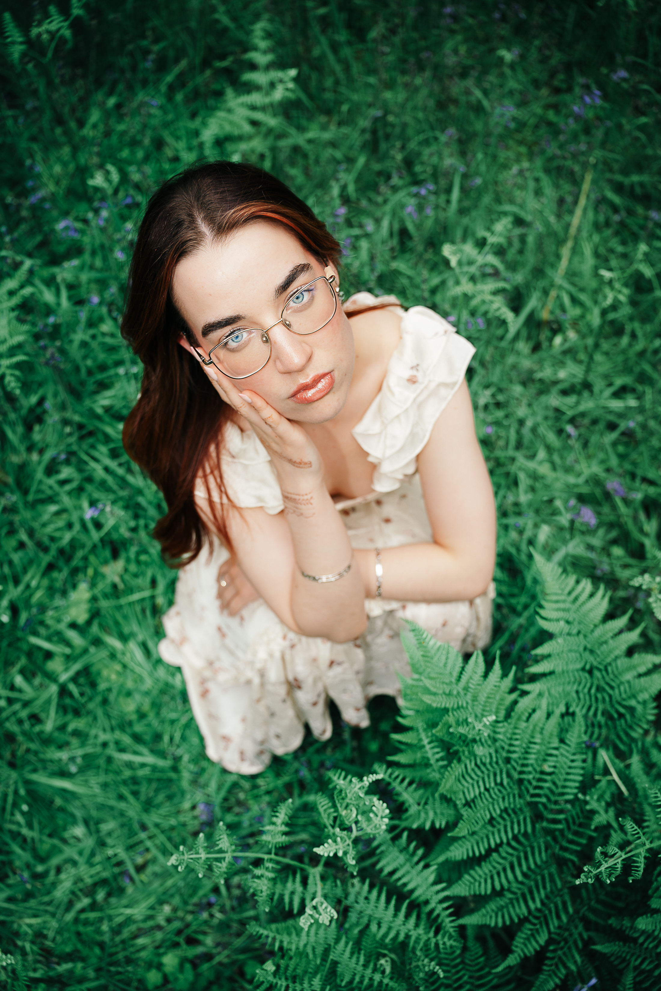 Full-length editorial portrait in a carpet of bluebells in ancient oak woodland, Scotland