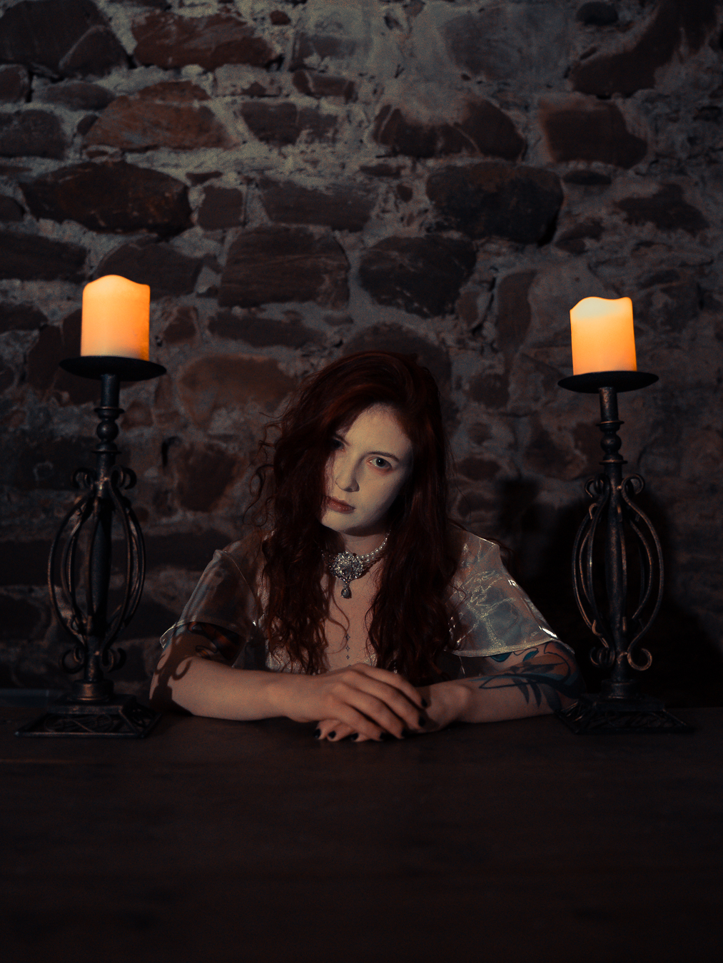 Candlelit gothic portrait at Portencross Castle, candle held at chest height