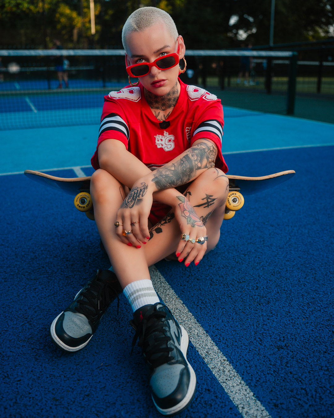 Model holding skateboard behind her head in red sunglasses, Red Court editorial series by DScotia Captures, Glasgow