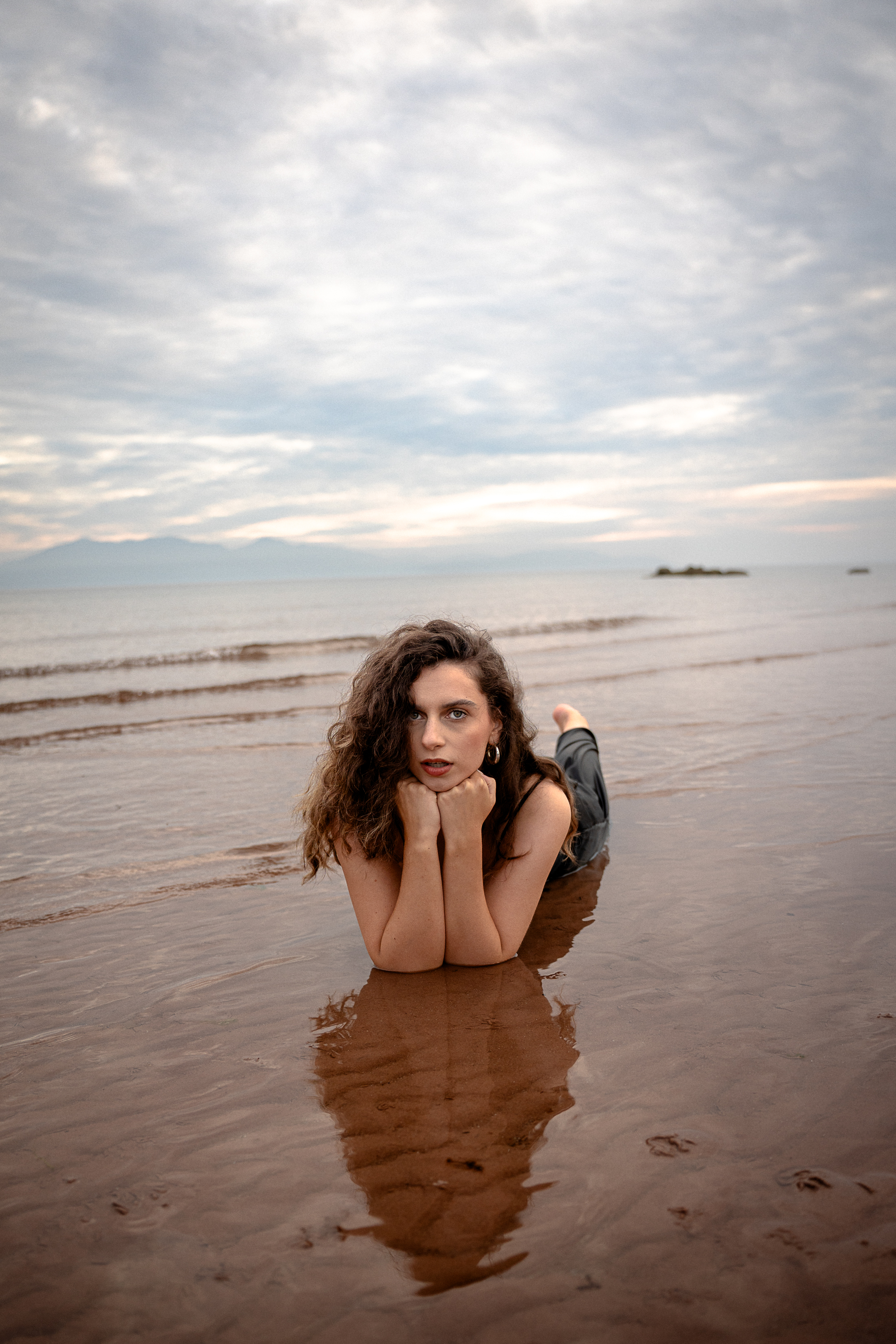 Full-length editorial movement shot in a flowing dress on the West of Scotland coast