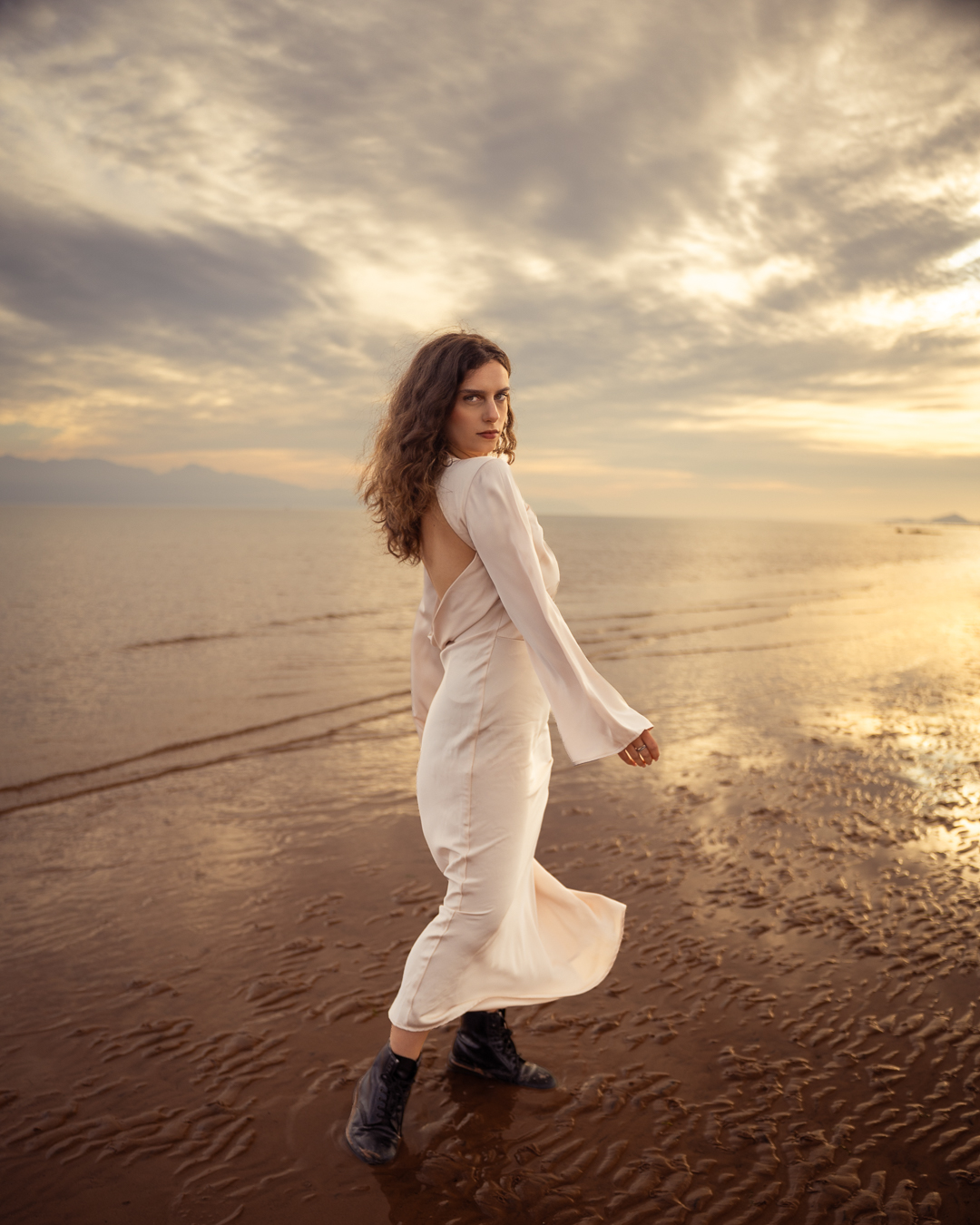 Black slip dress editorial portrait at dusk on Seamill beach, Scotland